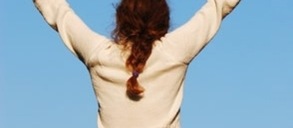 girl in white holding her hands up