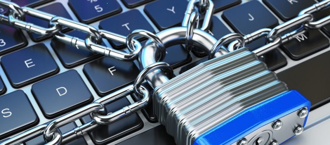 Computer security or safety concept. Laptop keyboard with lock and chain.