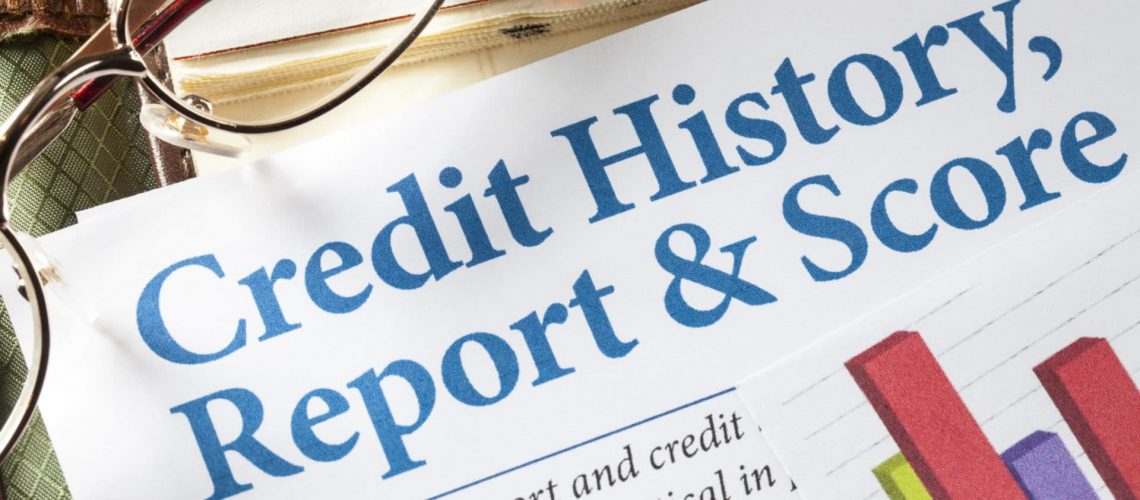 Credit History Report and Score with chart and glasses on desk